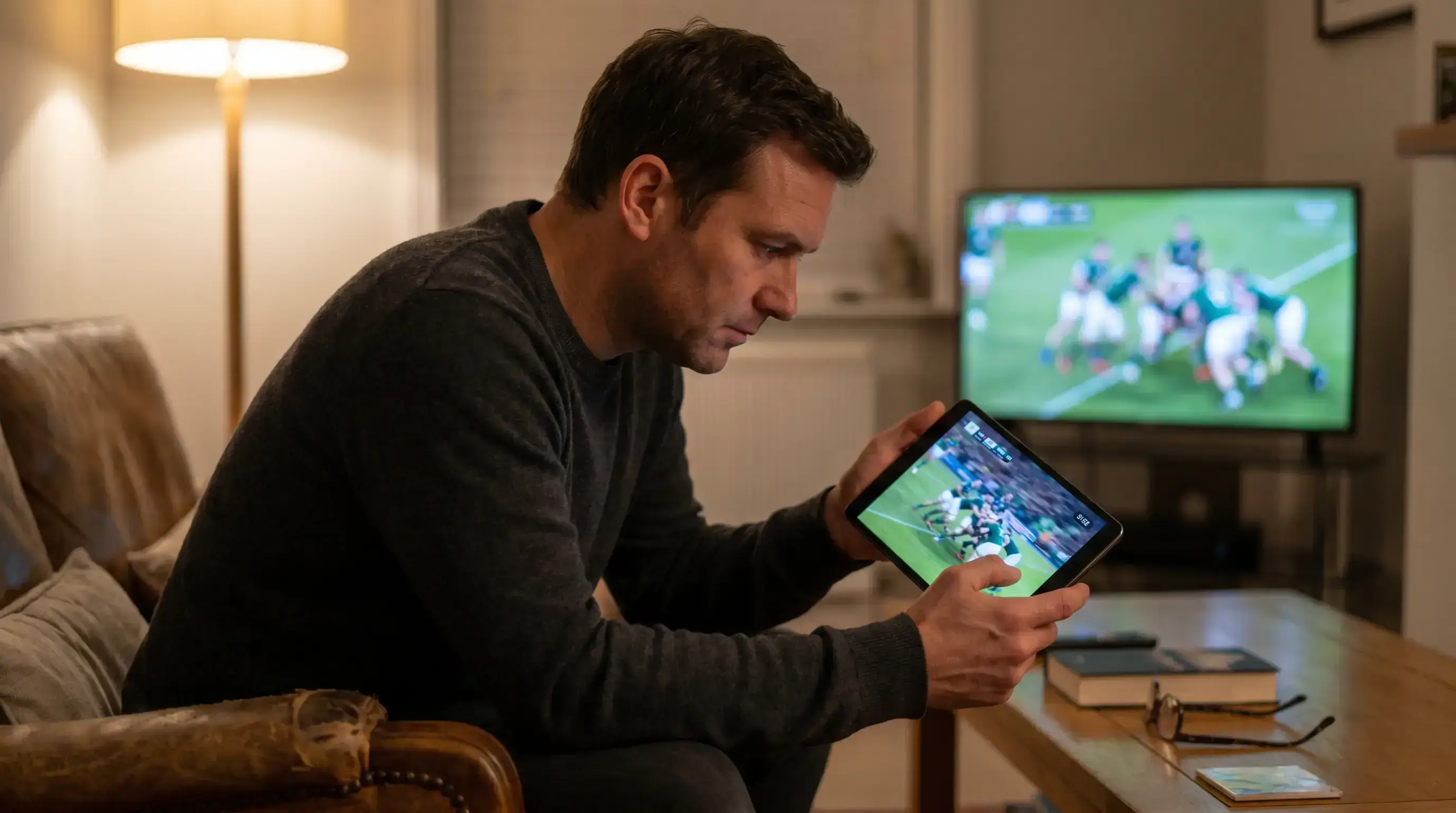 Person watching a rugby match on a phone with the live score visible