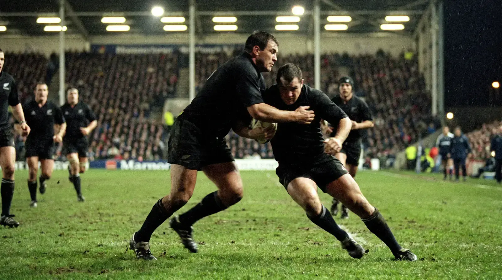 Rugby league forward making a dominant tackle on a ball carrier