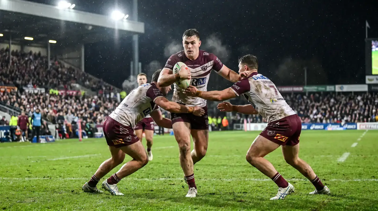 NRL rugby league player carrying the ball through defenders