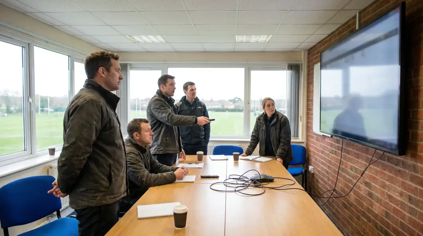 Rugby coaching staff watching a video review of attacking patterns