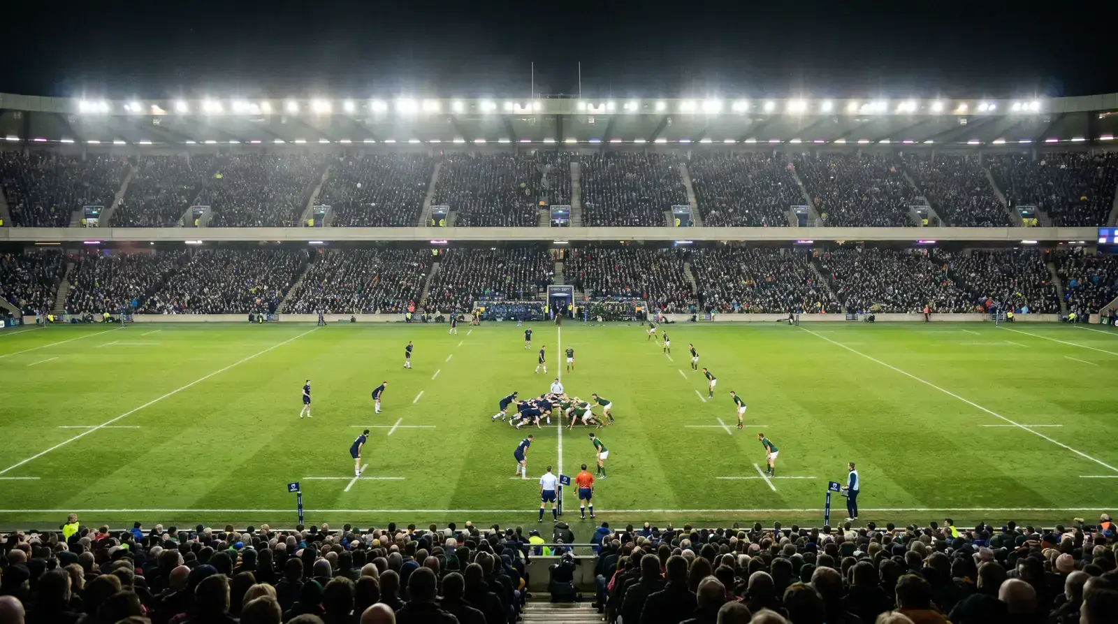 Knockout-stage Rugby World Cup fixture under floodlights with a full stadium crowd