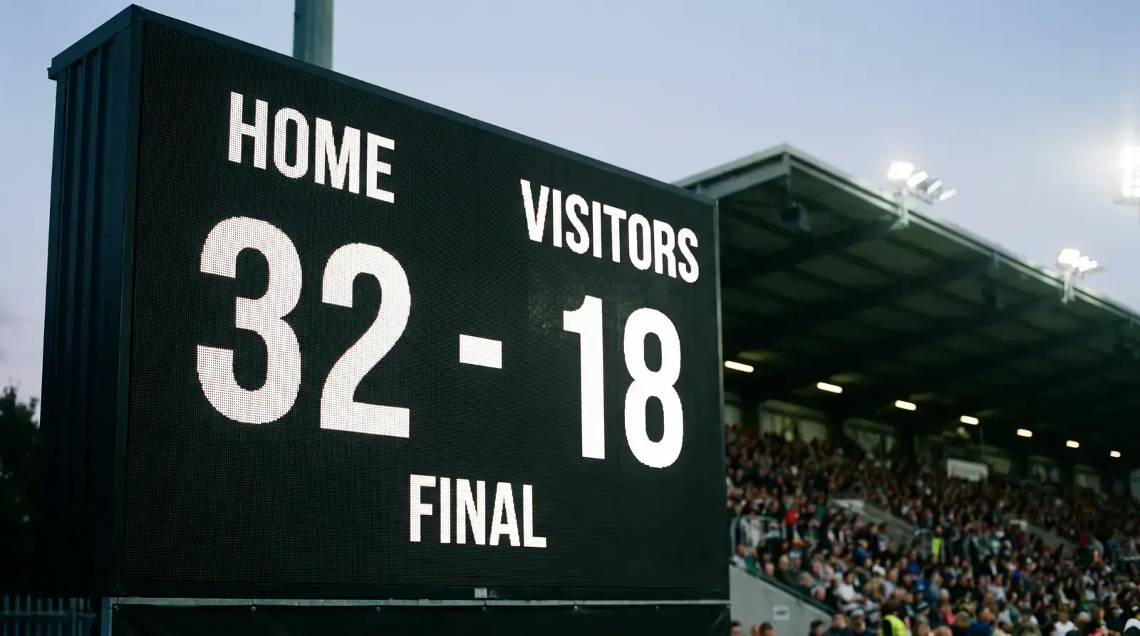 Rugby stadium scoreboard showing a final score split into a winning-margin band for betting